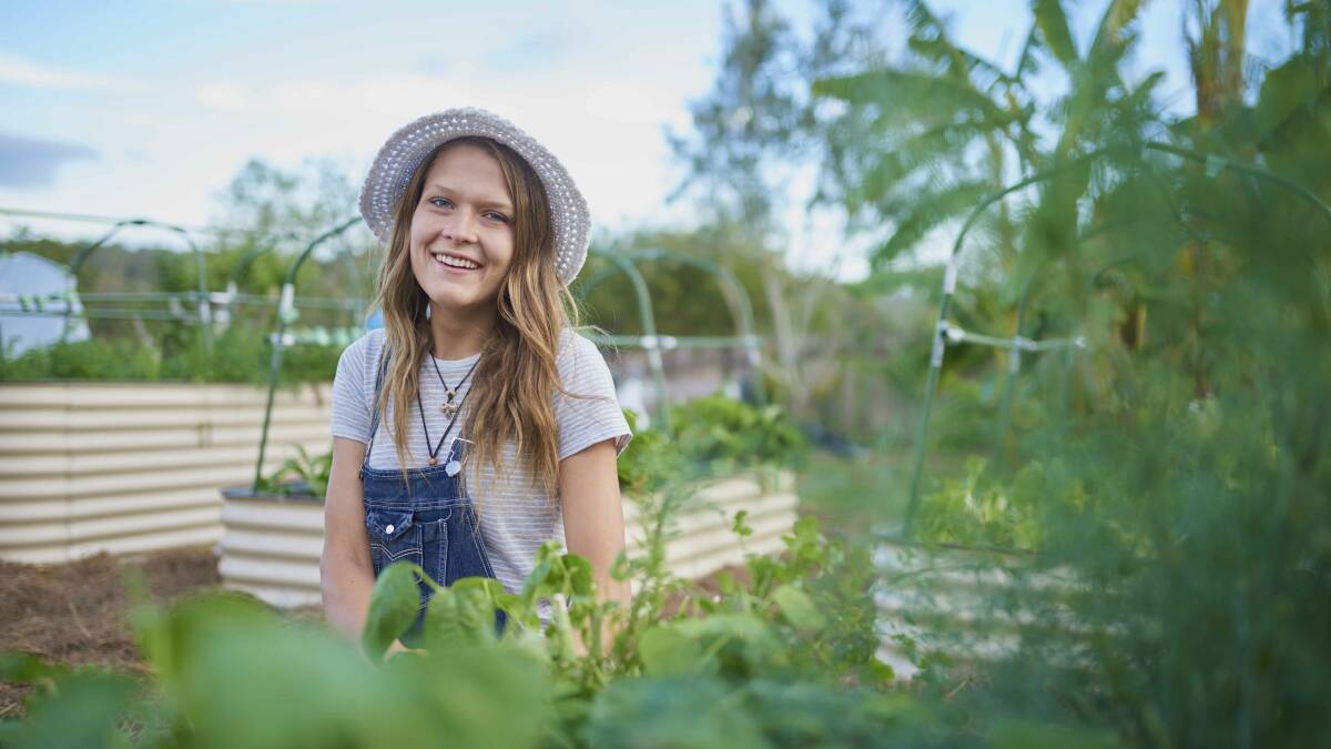 Garden queen: Chelsea Hands and the Manning Valley Community Gardens at Wingham will grace the front cover of the 2018 Taree Yellow and White pages directory. Photo: submitted