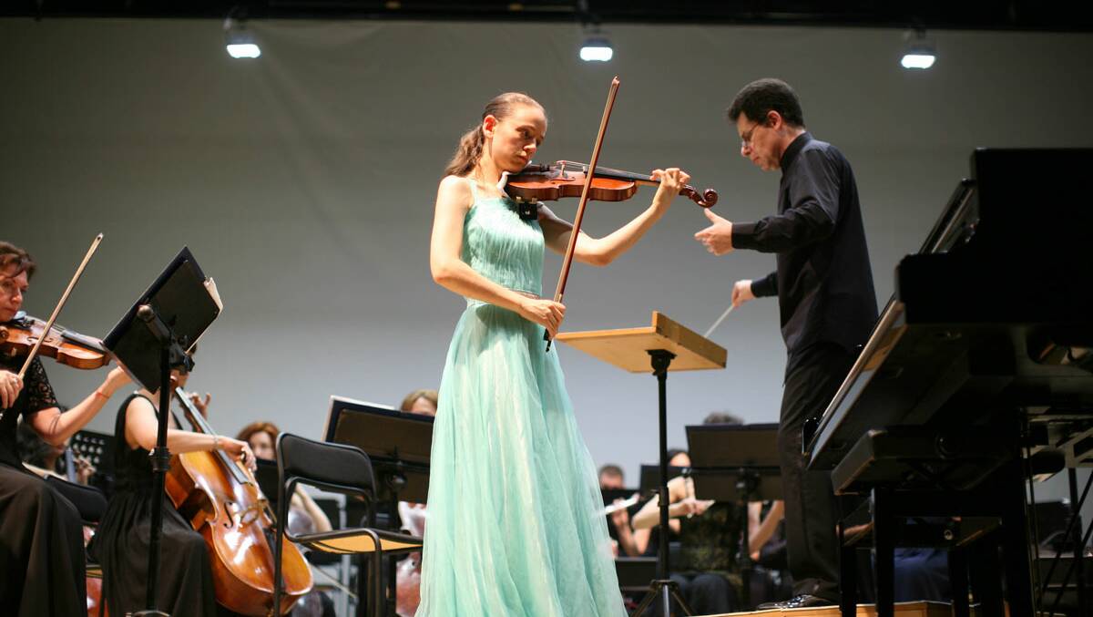 Linda Gilbert performing on stage with an orchestra. Photo supplied