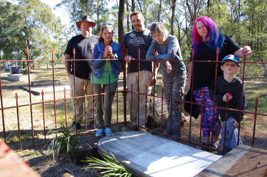 Dumbfounded: Scott Stewart, Caz Baker, Reece Pope, Rowene Stewart, and Amy-Lee Kneebone and her son at The Bight Cemetery, wondering why a gravestone that had been pulled out of the ground that was in a fenced off grave was considered a public risk. Photo: Julia Driscoll