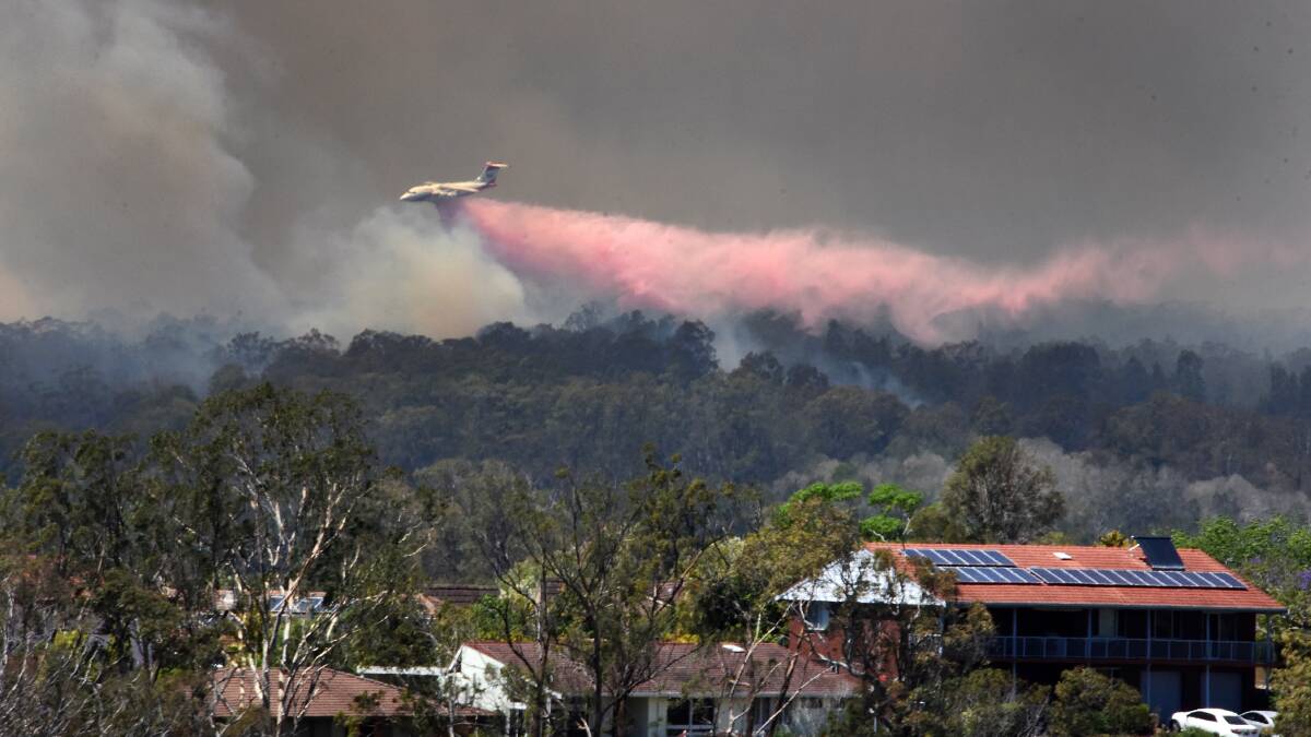Hillville fire: Fire retardant being dropped over the fire as seen from Taree. Photo: Scott Calvin