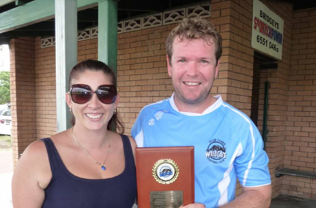 Dean Wilkins with his wife, Nicole and the plaque presented to him by the Taree Wildcats.