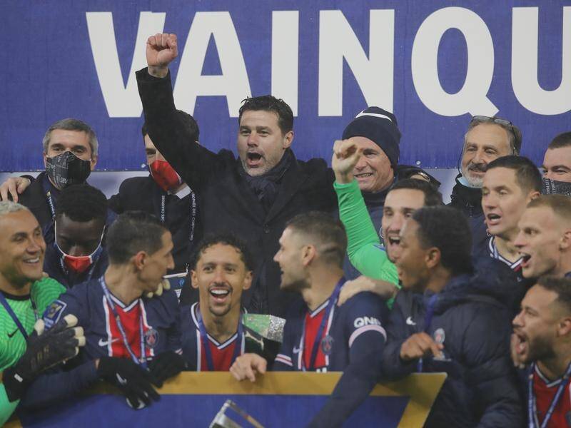 Mauricio Pochettino, fist raised, joined his PSG team in mask-free celebrations after their cup win.