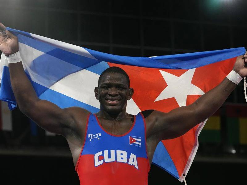 Cuba's Mijain Lopez Nunez celebrates winning his fourth Olympic wrestling gold medal.