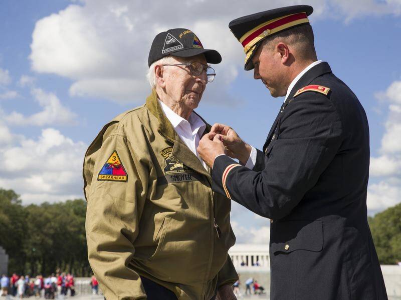 World War II veteran Clarence Smoyer receives the Bronze Star from US Army Major Peter Semanoff.
