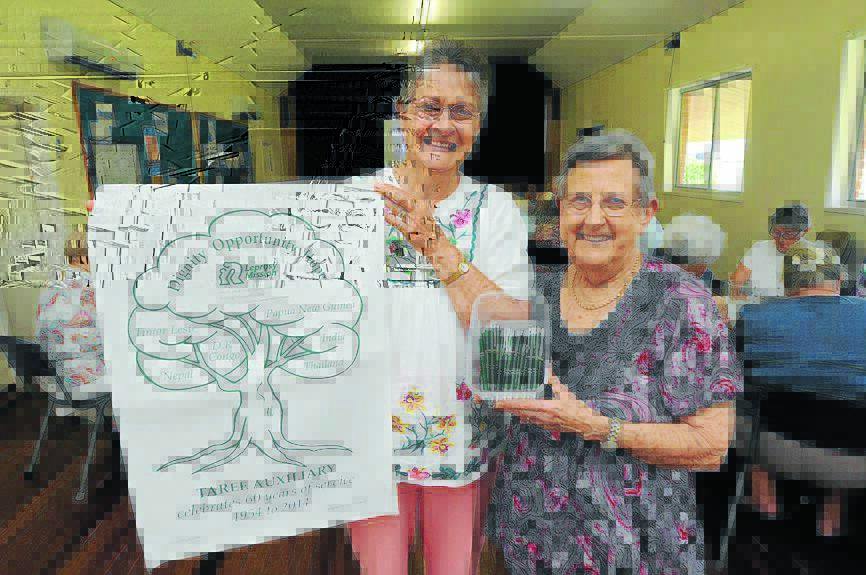 Ann Osmand and Phylis Smith with the 60th anniversary tea towel designed by Ann.