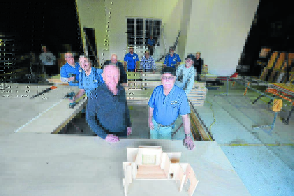Taree Arts Council president and Secret Bridesmaids' Business director Bruce Wiseman and Old Bar Men's Shed president David Denning with a miniature design of the show's set, of which the full-size set is being constructed by members of the Men's Shed.