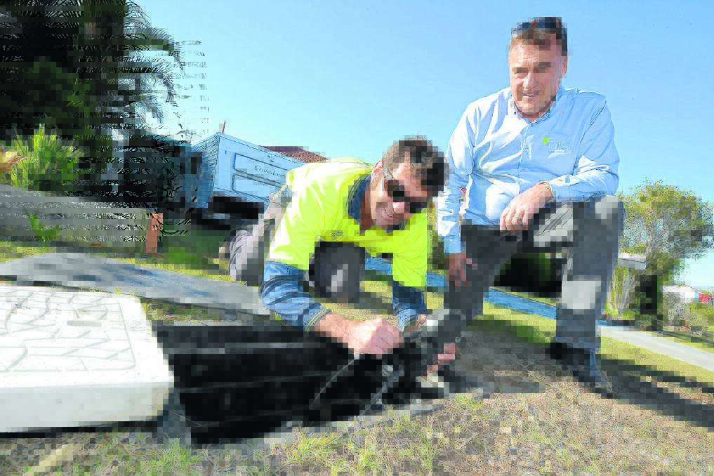 Father and son, David and Michael Relf connect the NBN to Ritchie Crescent, Taree last Friday.