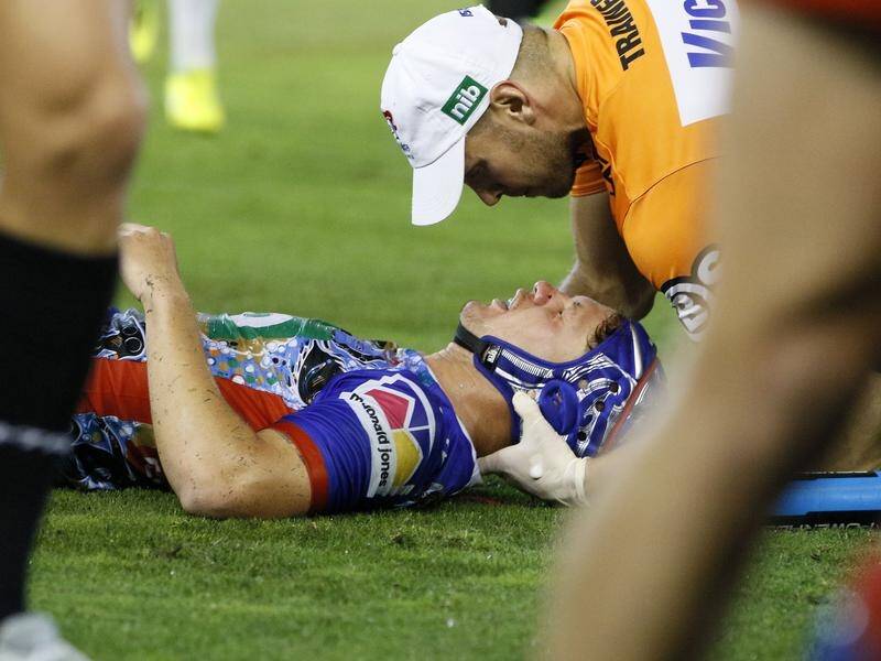 Newcastle fullback Kalyn Ponga feeling the tackle by the Roosters' Jared Waerea-Hargreaves.