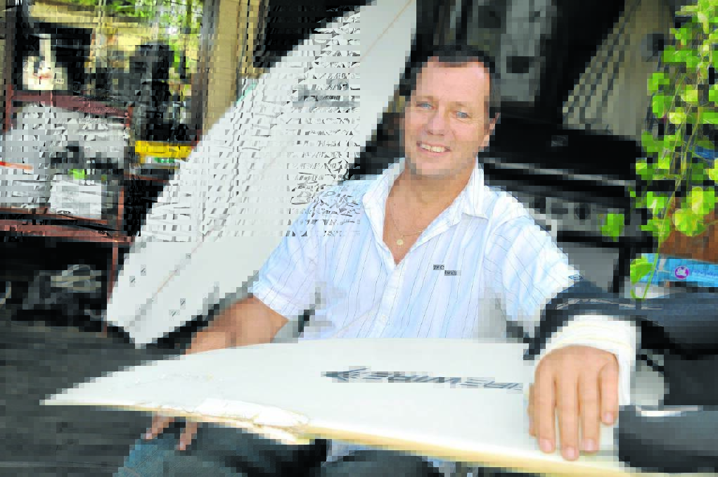 Dave Pearson pictured at home in 2011 recovering from a shark attack. He now wears a shark repellant wristband to deter the predators.