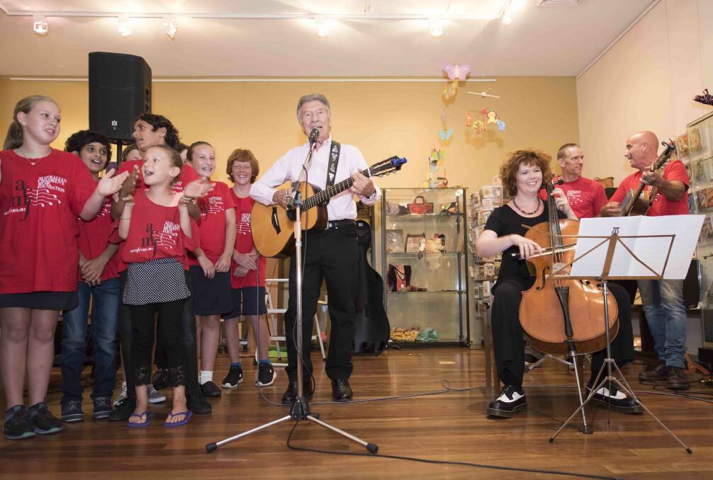 Students from Taree Public School on stage with ACMF founder Don Spencer, cellist Rachel Scott and ACMF teachers Michael Eyb and Matt Zarb.