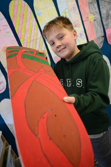 Lachlan Cross with his skateboard artwork.