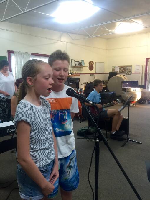 Charlotte Reece and Connor Langley practice a song for Carols in the Park.