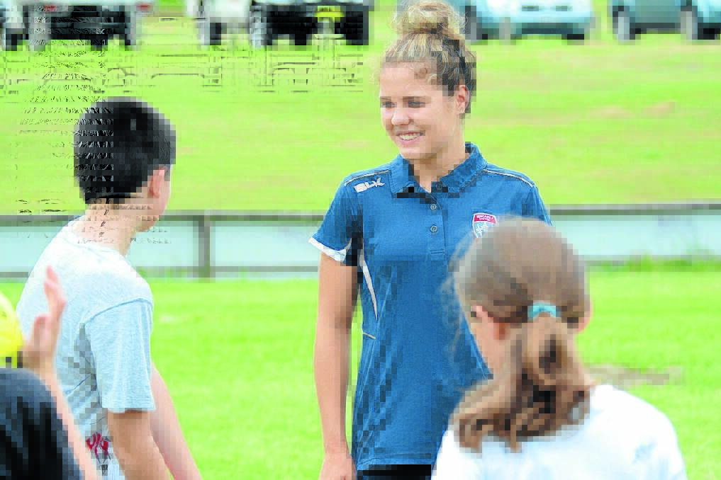 Sophie Nenadovic helps spread the football gospel at the Taree registration day.