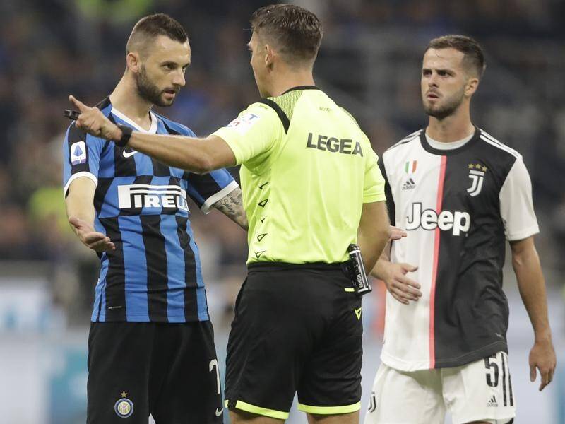 Inter Milan's Marcelo Brozovic questions a decision by referee Gianluca Rocchi.