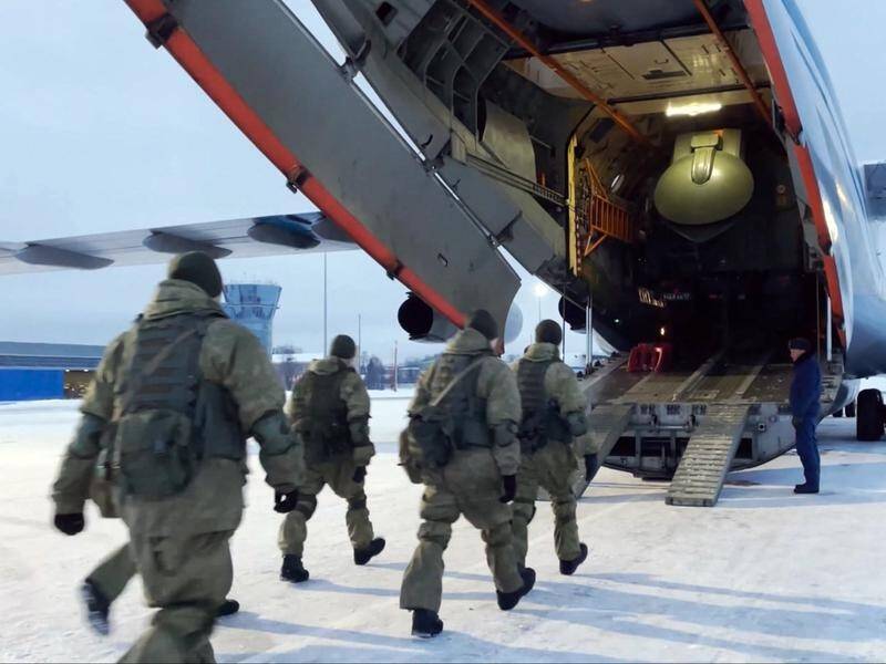 Russian troops board a military plane outside Moscow to fly to Kazakhstan to help quell protests.