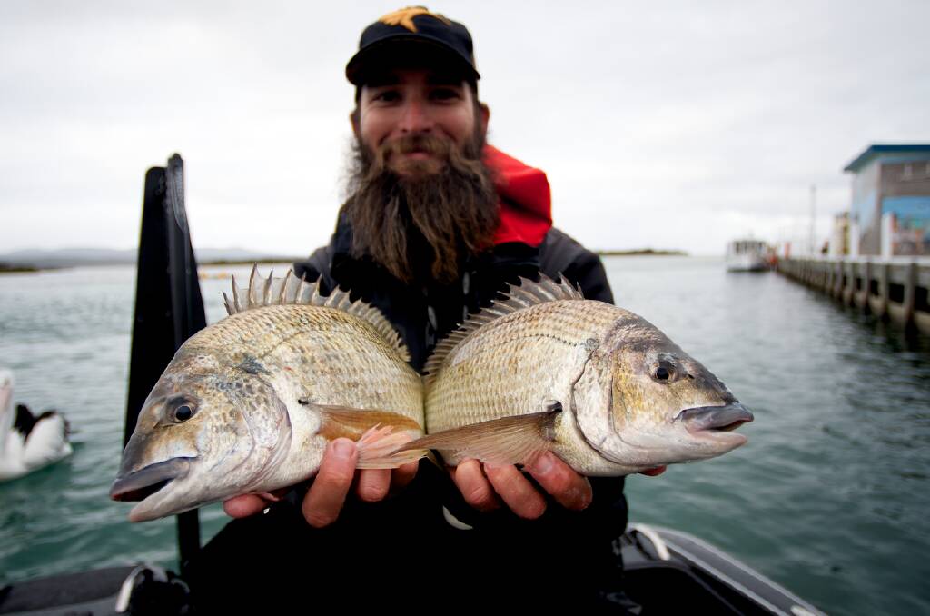 Australia's number one bream angler Kris Hickson holds two bream after winning an ABT Bream round in Mallacoota in 2015.
