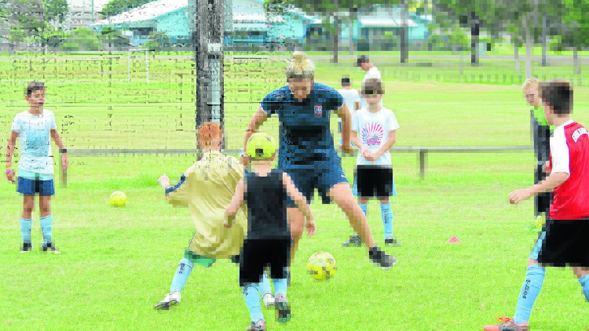 Jets star Brooke Miller works with Taree juniors during the registration day held at Omaru Park.
