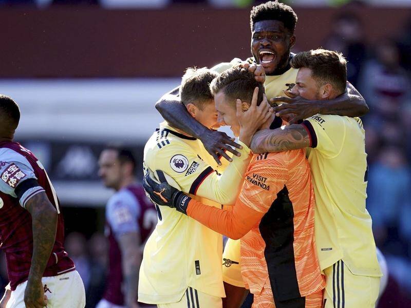 Arsenal goalie Bernd Leno celebrates with teammates after a key late save in the win at Aston Villa.