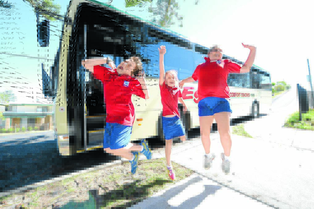 Harrington Public School students Tristan Gannon, Lilly Benson and Jorja McMahon express their joy at the new bus service.
