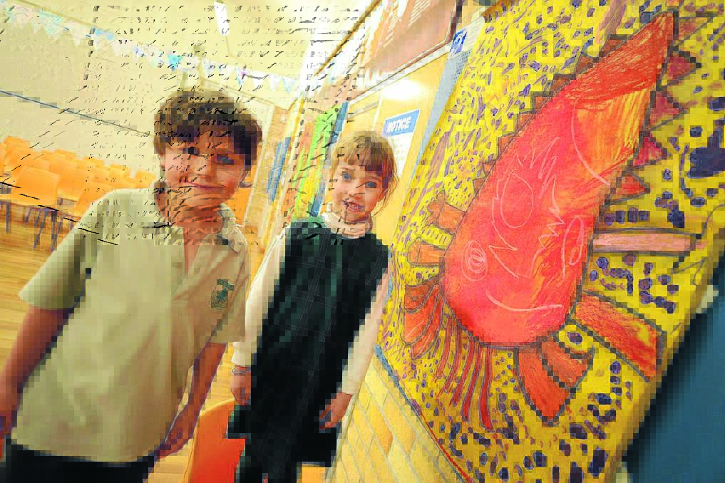 Indy Sheridan and Emma Lambert from kindergarten with one of the collaborative artworks.