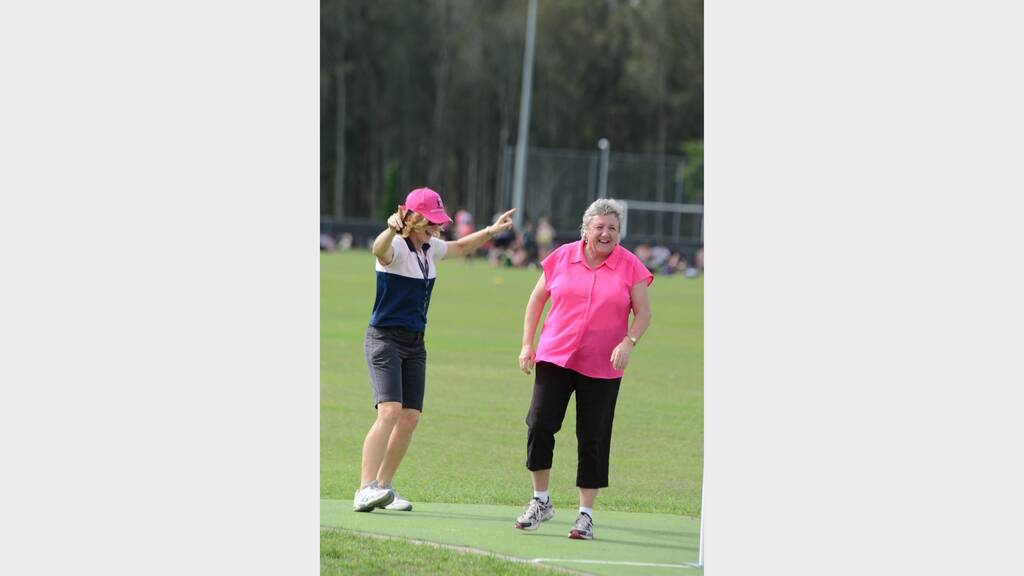 Umpire Mrs Jenny Fotheringham signals a wide by bowler Ms Sue LeStrange in the Chatham High Pink Stumps Day.