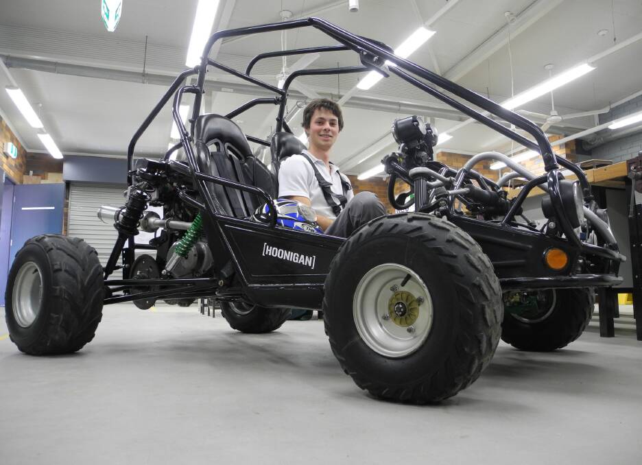 Wingham High's Mathew Percival with his 'Hoonigan' off road buggy - the HSC project will be on display this week at the Manning Regional Art Gallery