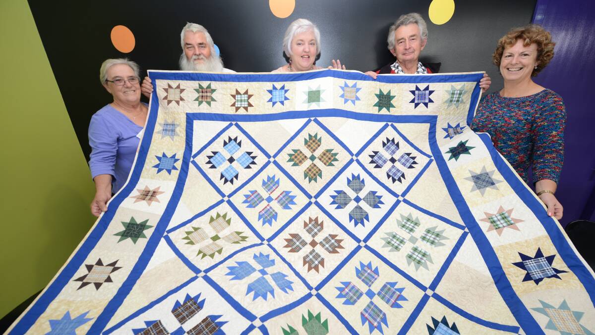 Hundreds of hours of meticulous stitching by members of River City Community Quilters (RCCQ) has created a quilt that will be raffled to support grandparents who care for their grandchildren full-time. Grandparents As Parents Again (GAPA) president, Ann Battishall (left) with Allan Battishall, RCCQ co-ordinator Denece Unicomb and Neville Unicomb with Rotary Club of Taree North president Susan Bell.