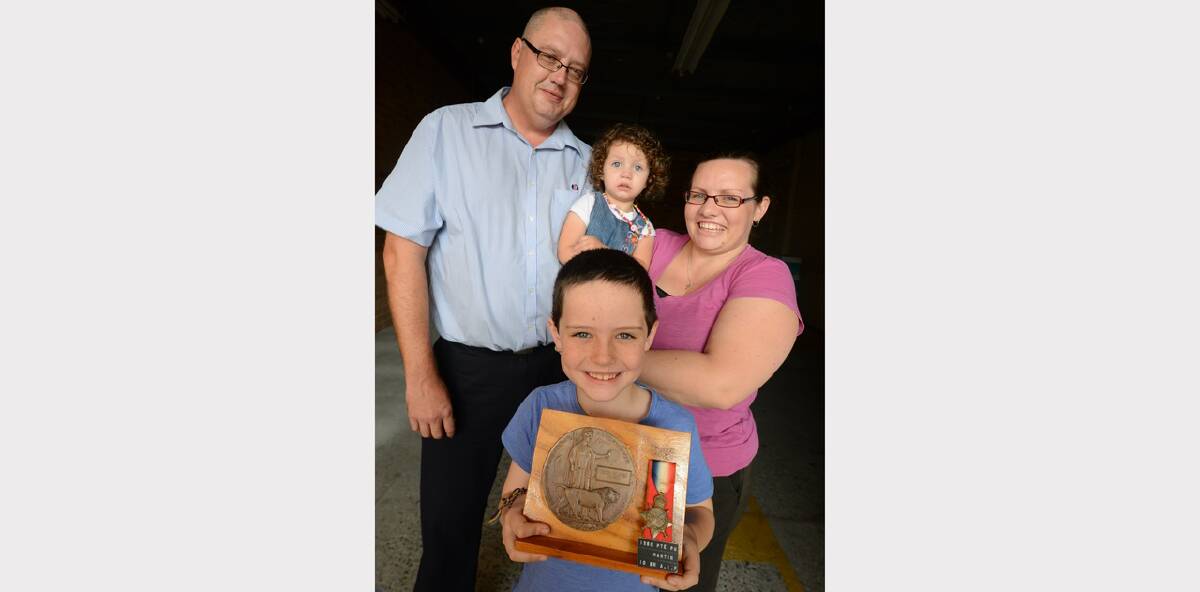 Kristian Martin (front) with his proud parents, Nik and Sarah and sister, Kianah (centre). The Cundletown Public School student is holding his great great uncle Percy Martin s military medal, which he will carry at Taree s Anzac Day march on Friday.