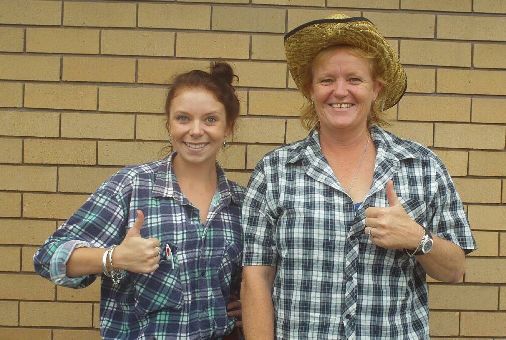 Thumbs up for farmers! Sophie Paff and Liz Eveleigh dressed in country-style clothing to add a little fun to the Dollar4Drought Campaign fundraiser.