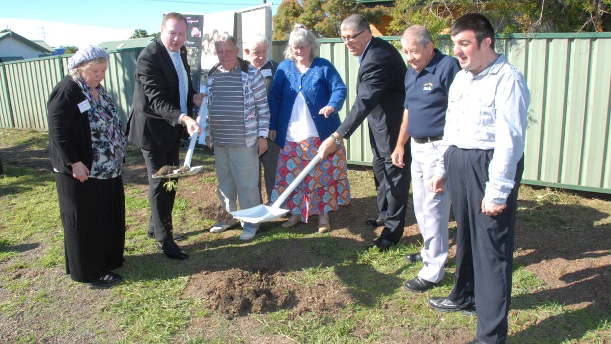 Member for Myall Lakes, Stephen Bromhead and the Minister for Disability Services, John Ajaka, christen new white shovels during the sod turning ceremony for the new Dundaloo Support Services group home in Taree. Celebrating with them are some of clients who will call the Stevenson Street house their home, (from left) Lindell Prince, Steve Curtin, Athol Welsh, Lyn Bolte, neighbour Tony Thompson and Damien Herring.