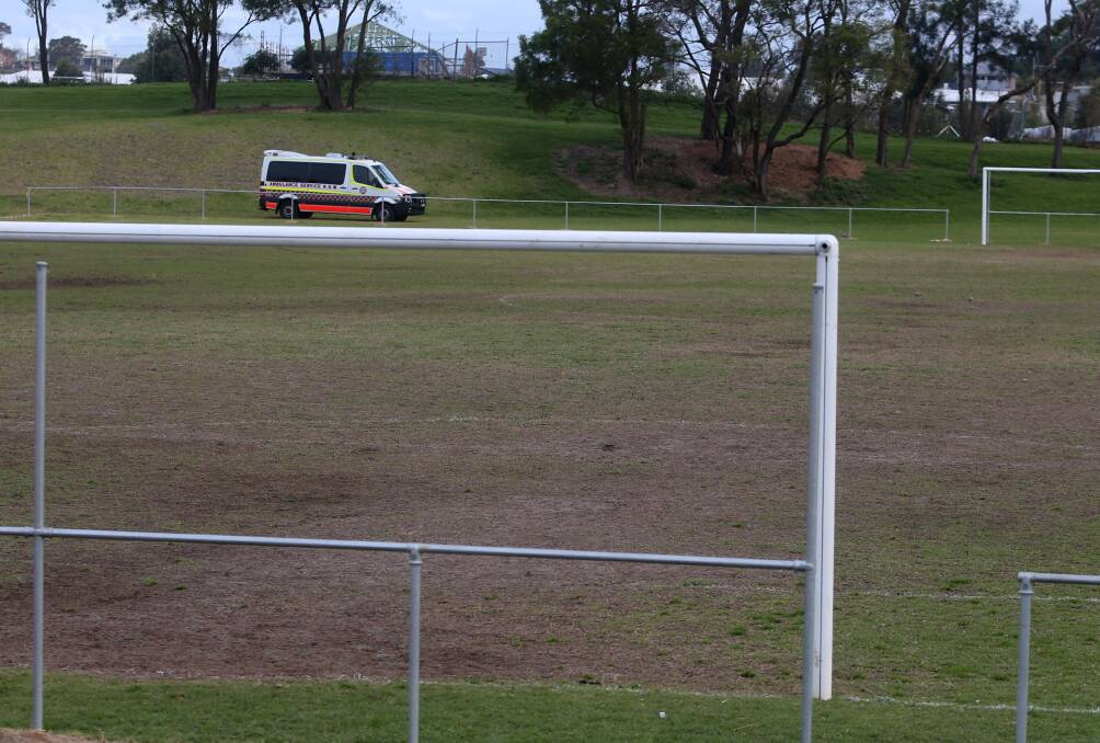 One of three ambulances remained near the soccer field after the emergency at Gibson Park on Saturday afternoon. Picture: Robert Peet
