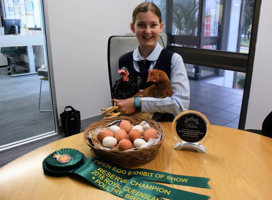 Katie with her ribbons and trophy from the Queensland Royal Show as well as an array of her prized super eggs. 
