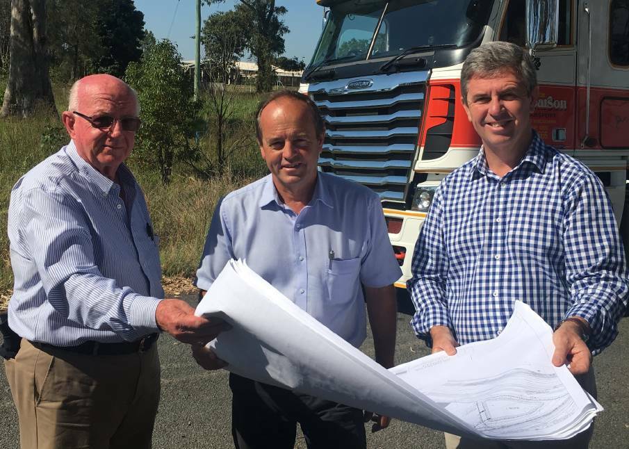 Roy Cottrell, Jim Pearson and Dr David Gillespie inspect plans for the proposed Northern Gateway Transport Hub.