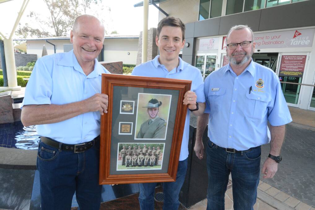 With the rightful owner: Taree RSL Sub-branch's Darcy Elbourne and John Connell presented Anthony Whitaker with his framed photo. How it ended up in their possession remains a mystery. Photo: Scott Calvin.
