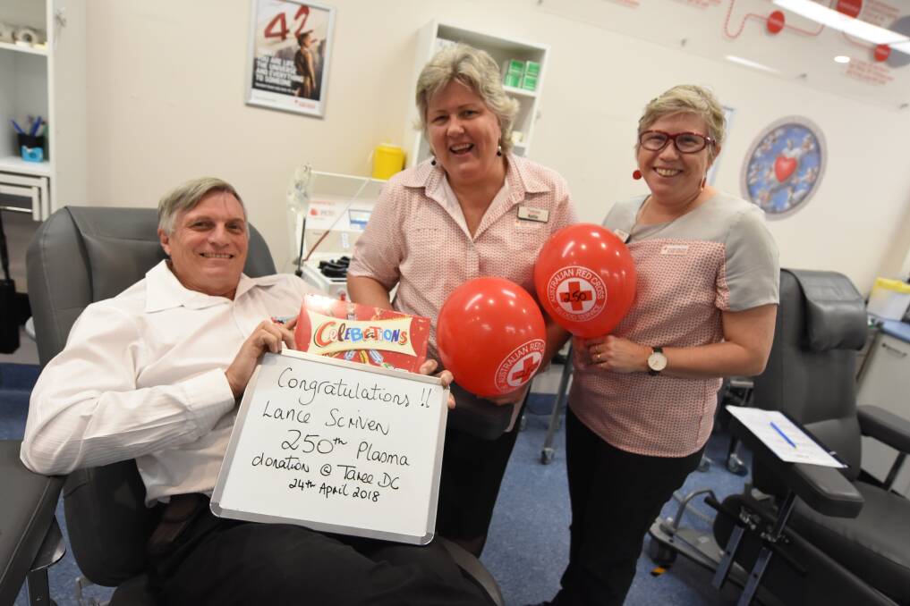 Big achievement: Lance Scriven with Taree Blood Centre manager Kellie Harrison and nurse Ange Callaghan. Photo: Scott Calvin. 