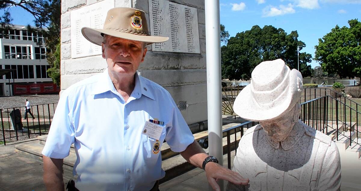Taree RSL Sub-branch vice president Darcy Elbourne with the solider statue at the front of the Taree War Memorial.