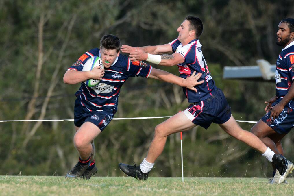 Dean Mills attempts to bring down Wauchope's Michael Smith in Saturday's major semi-final.