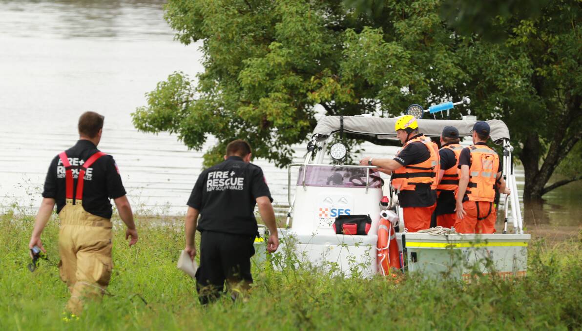 State Emergency Service and Fire and Rescue personnel near flood water in Taree in March.