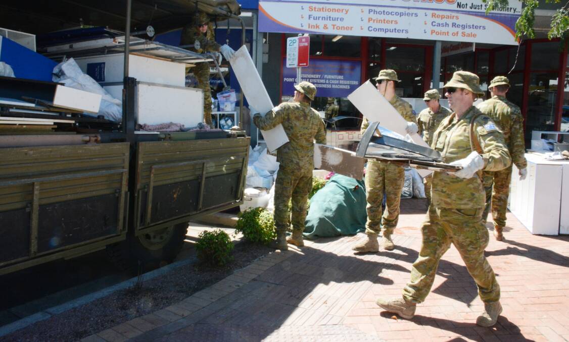 Helping hands: Army reservists removed damaged furniture from the Vinnies store on Pulteney Street. Photo: Scott Calvin.