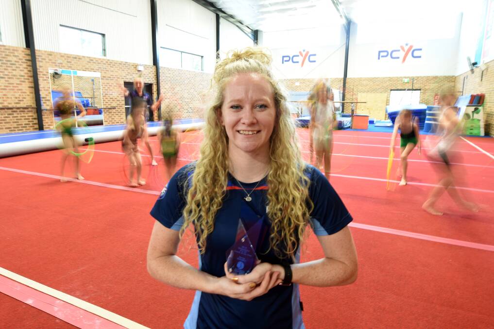 Leader: Penny Schubert, pictured with her Coach of the Year award,  is the head gymnastics coach at PCYC Taree. Photo: Scott Calvin.