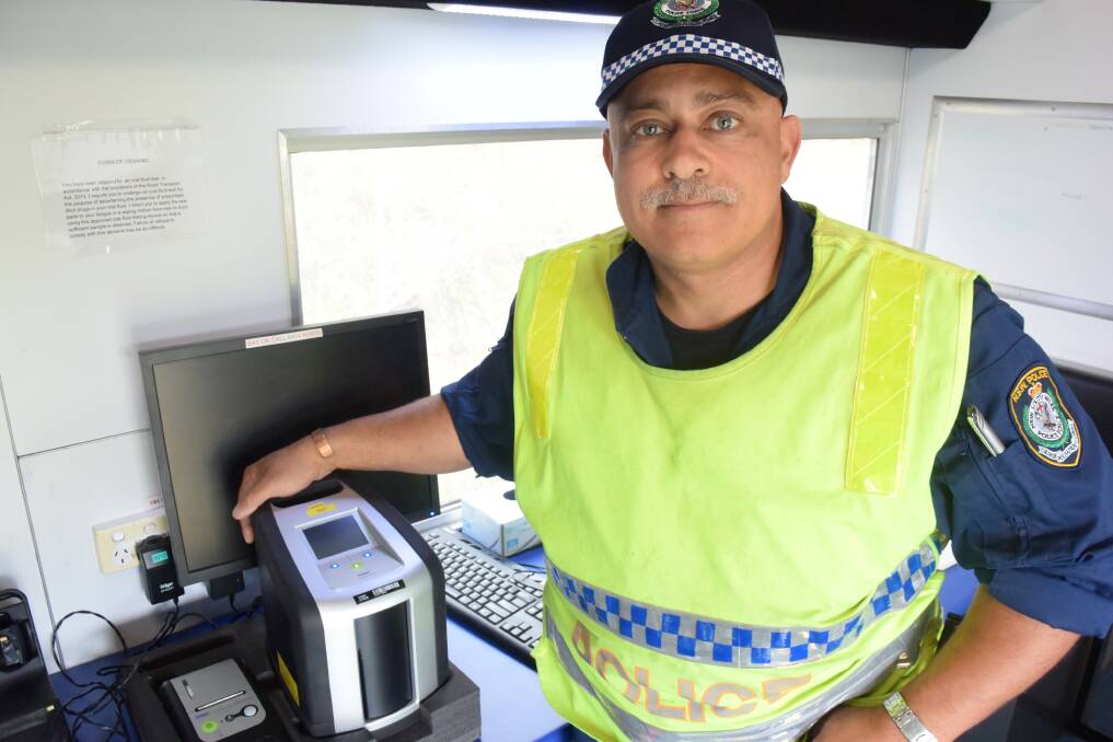 Operation Manning: Senior Constable Garrett Thebus with a drug testing machine used during the blitz south of Taree. Photo: Rob Douglas.