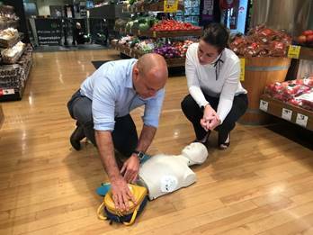 Woolworths managing director Claire Peters and Integrity Health and intensive care paramedic Liam Harte demonstrate a defibrillator. 