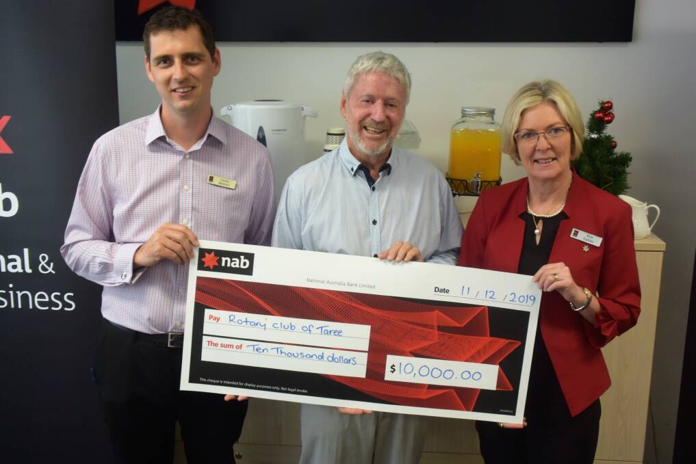 For the victims: National Australia Bank's Corey Beeton and Kim Dahler with Rotary Club of Taree on Manning projects manager Maurie Stack. The bank presented a $10,000 donation. Photo: Rob Douglas.