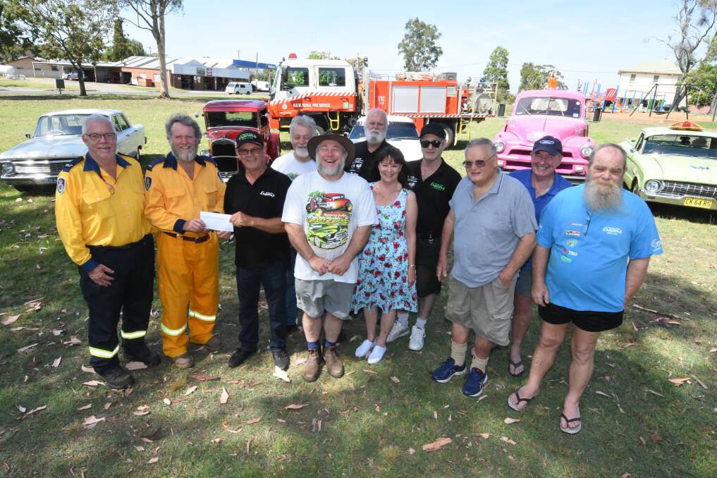 Welcomed donation: Kundle Moto Fire Brigade's Kevin Organ and Peter Longworth accepted the donation from Peter Green, Kim Fetherston, Pat Holden, Jenny Carter, Mark Eade, Peter Russell, Tom Carson, Selwyn Currie and Dean Stafford. Photo: Scott Calvin. 