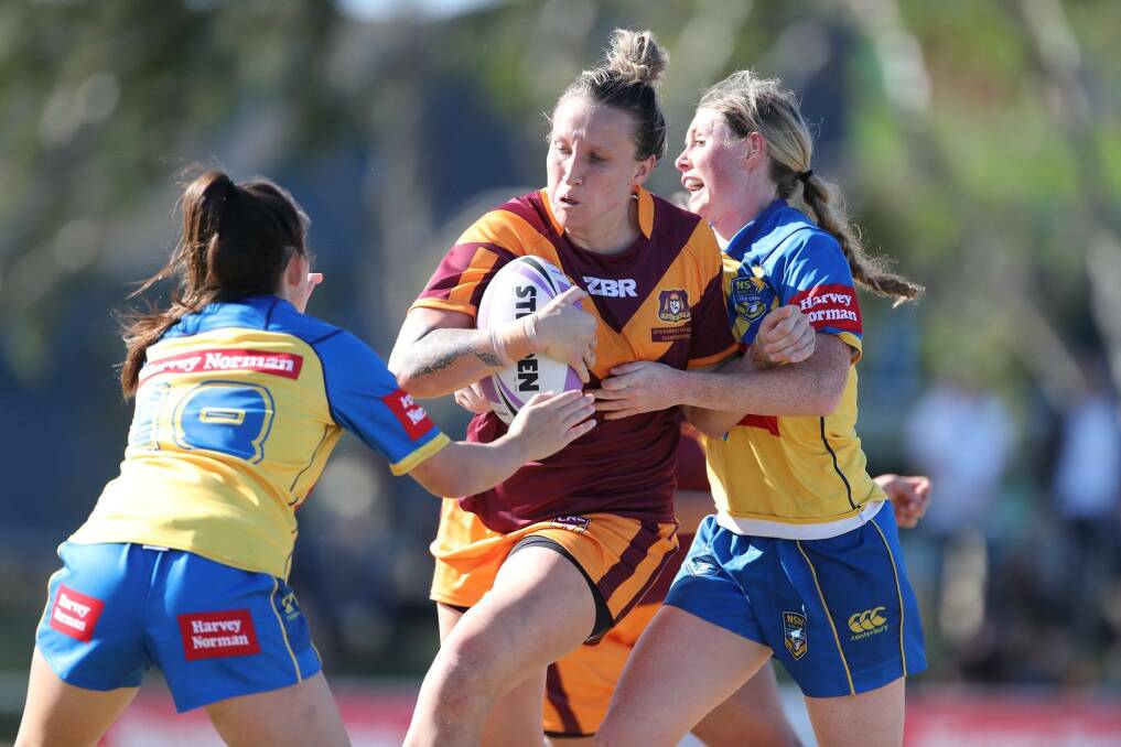 On the attack: NSW Country second rower Holli Wheeler takes a hit up against City. She featured in all three games for the side, including the final. Photo: Country Rugby League. 