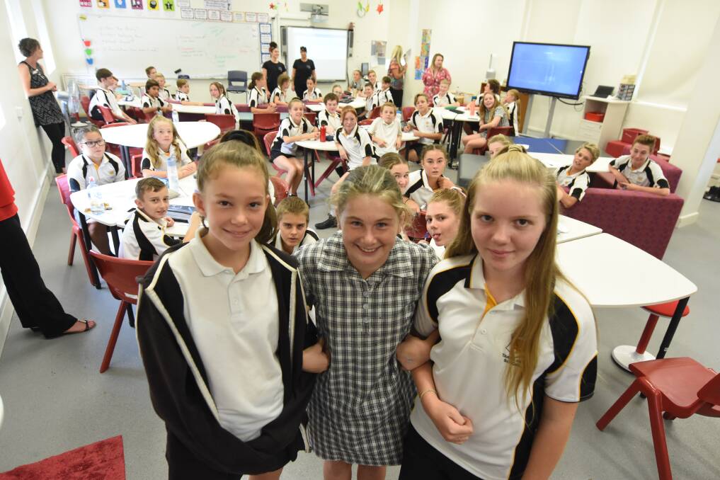 Fun and learning: Taree High School year seven students Abby Nowlan, Tayla Silcock and Amber Stewart with their classmates during the Anti-Bullying Project workshop. Photo: Scott Calvin.