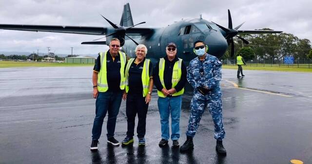 A helping hand: Rotarians Laurie Easter, David Denning and Barry Levick with a C-27J Spartan crew member at Taree Airport. Photo: supplied.