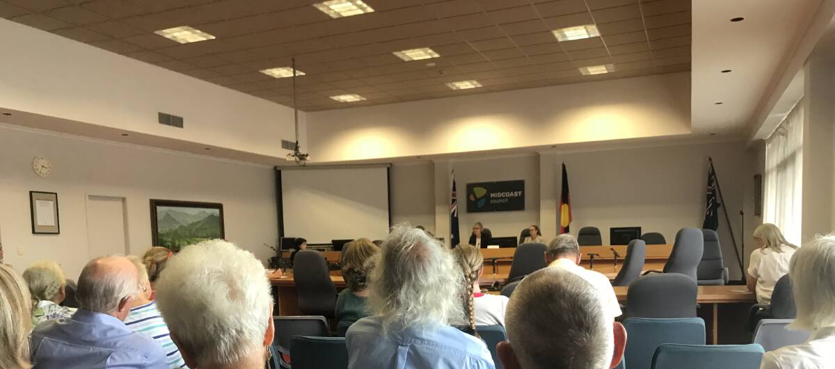 Members of the gallery listen to the outcome of the Hunter Central Coast Regional Planning Panel in relation to MidCoast Council's application to move to the former Masters site.