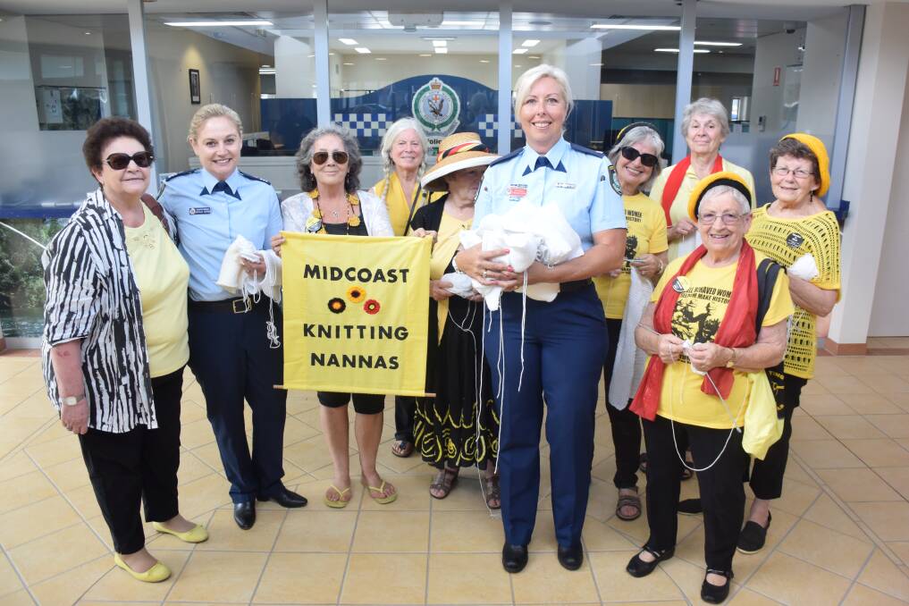 Community support: MidCoast Knitting Nannas hand their contributions to Taree Police Station's Detective Sergeant Natalie Antaw and Chief Inspector Christine George.
