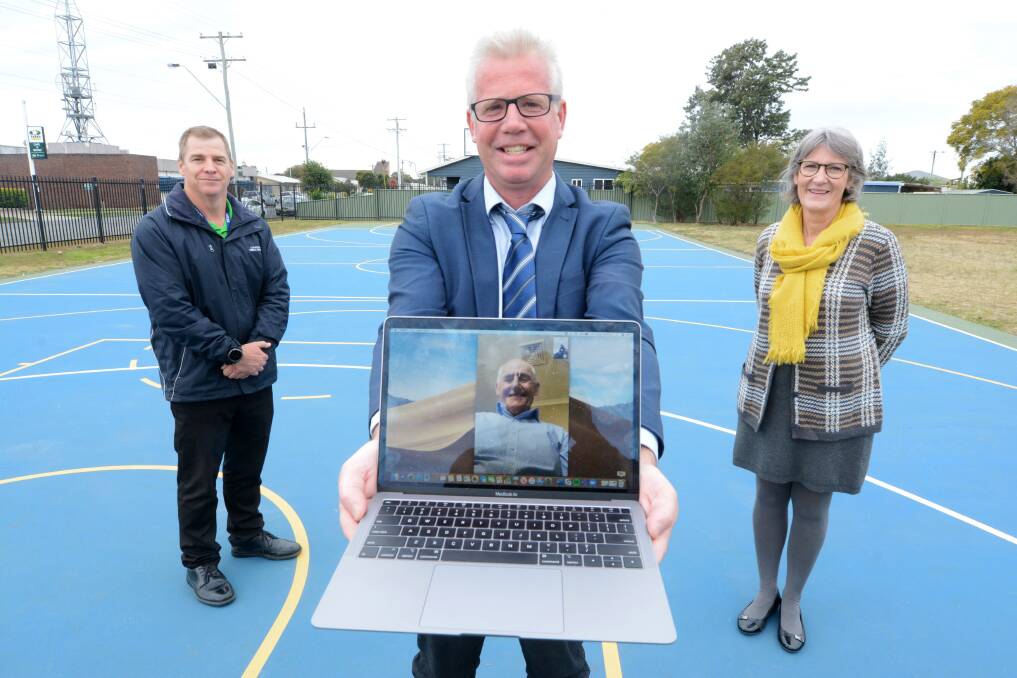 Dedication: Professor Stephen Powles (on computer screen) donated funds to build a multipurpose court at Chatham Public School. He was given a tour by principal Matthew Royan, Alison Clifton and Matthew Muller. Photo: Scott Calvin.